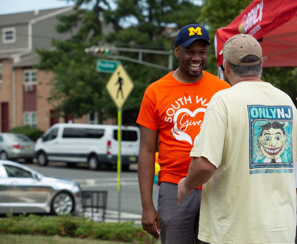 Dominique Lee speaks with a South Ward resident at a community event.